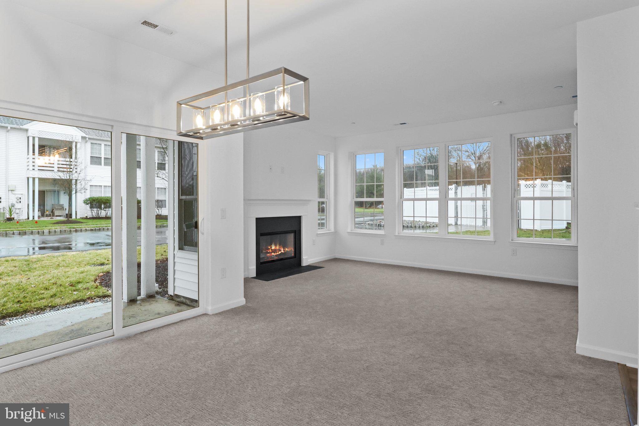 11112 Cornerstone Drive Yardley, PA 19067 - Photo 14 of 25 a view of empty room with fireplace and windows