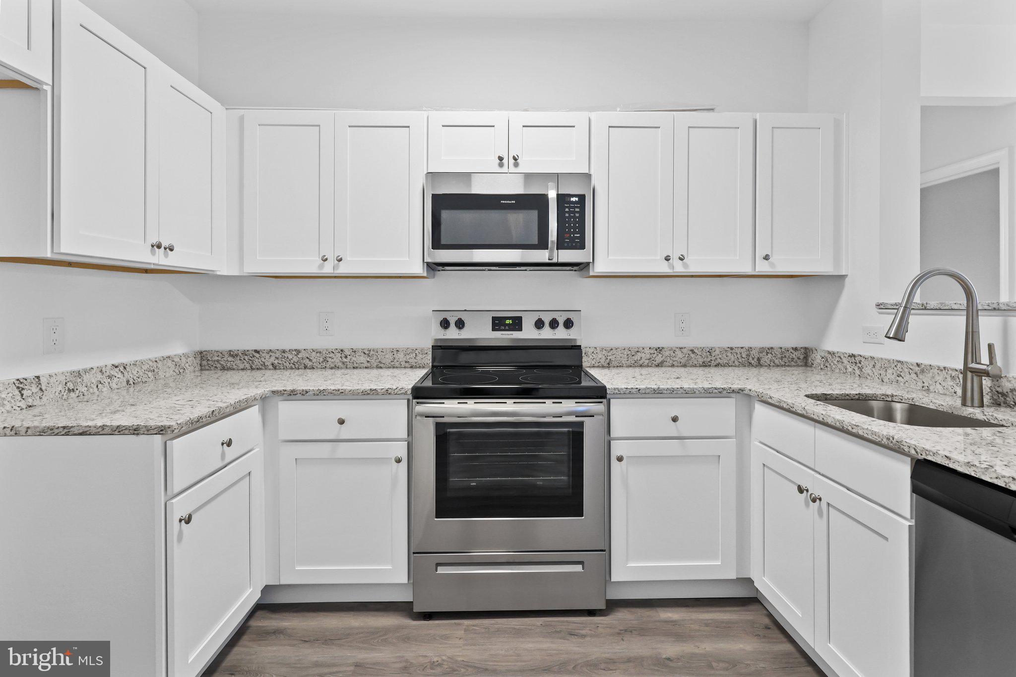 11112 Cornerstone Drive Yardley, PA 19067 - Photo 9 of 25 a kitchen with white cabinets and stainless steel appliances