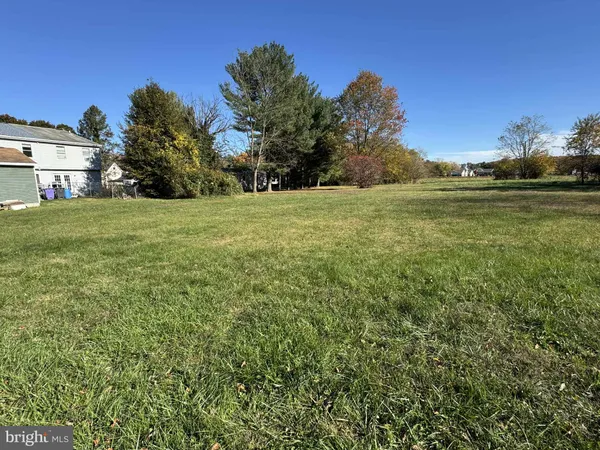 a view of a field of grass and trees