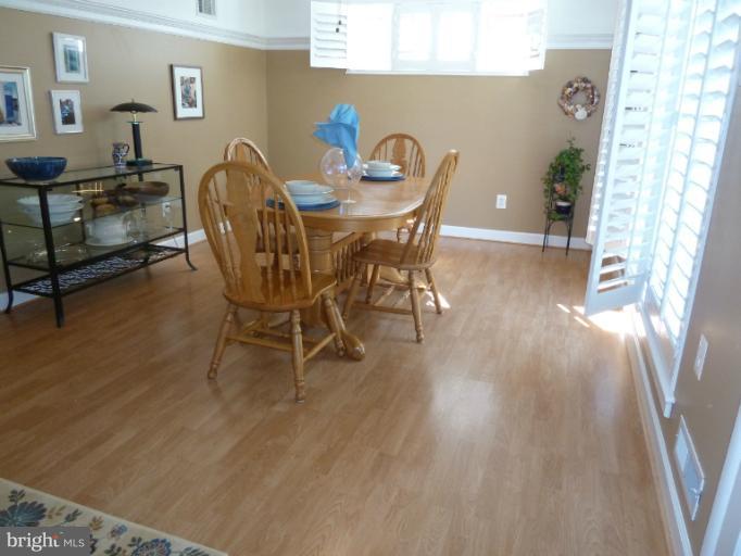 12908 Bluhill Road Silver Spring, MD 20906 - Photo 12 of 26 a view of a dining room with furniture and wooden floor