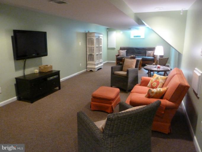 12908 Bluhill Road Silver Spring, MD 20906 - Photo 3 of 26 a living room with furniture and a flat screen tv
