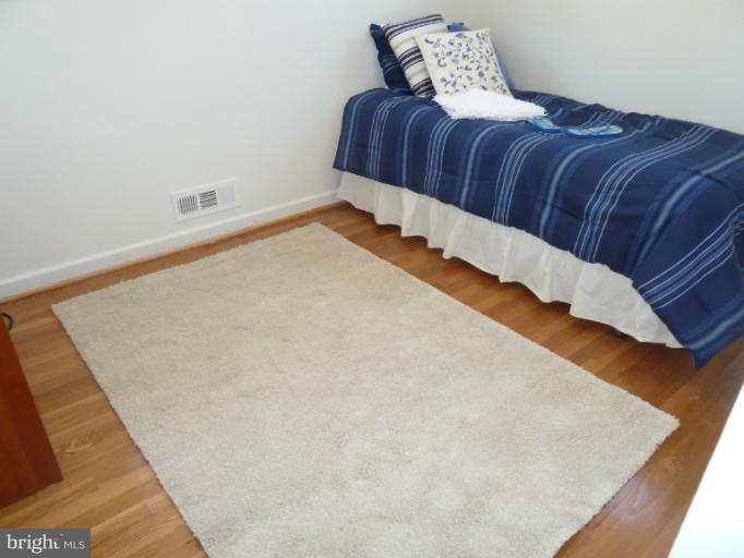 12908 Bluhill Road Silver Spring, MD 20906 - Photo 21 of 26 a bedroom with a bed and a night stand