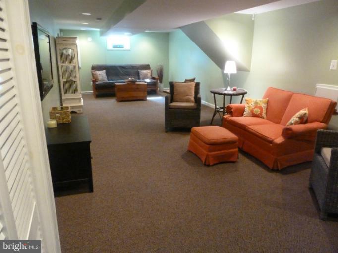12908 Bluhill Road Silver Spring, MD 20906 - Photo 22 of 26 a living room with furniture and a couch