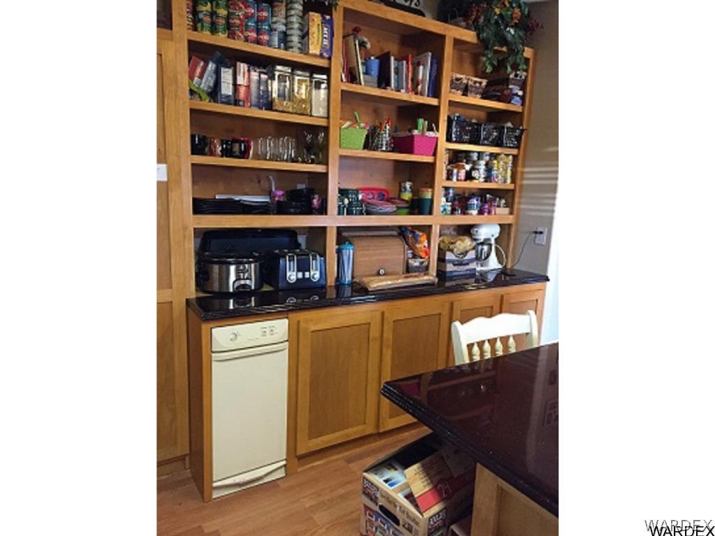 3995 Eloy Road, Unit 66 Golden Valley, AZ 86413 - Photo 15 of 27 a shelf with books and knick knacks on it