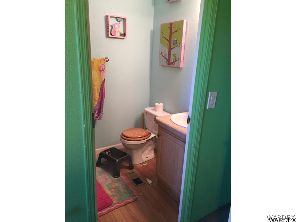3995 Eloy Road, Unit 66 Golden Valley, AZ 86413 - Photo 20 of 27 a bathroom with a toilet and a sink