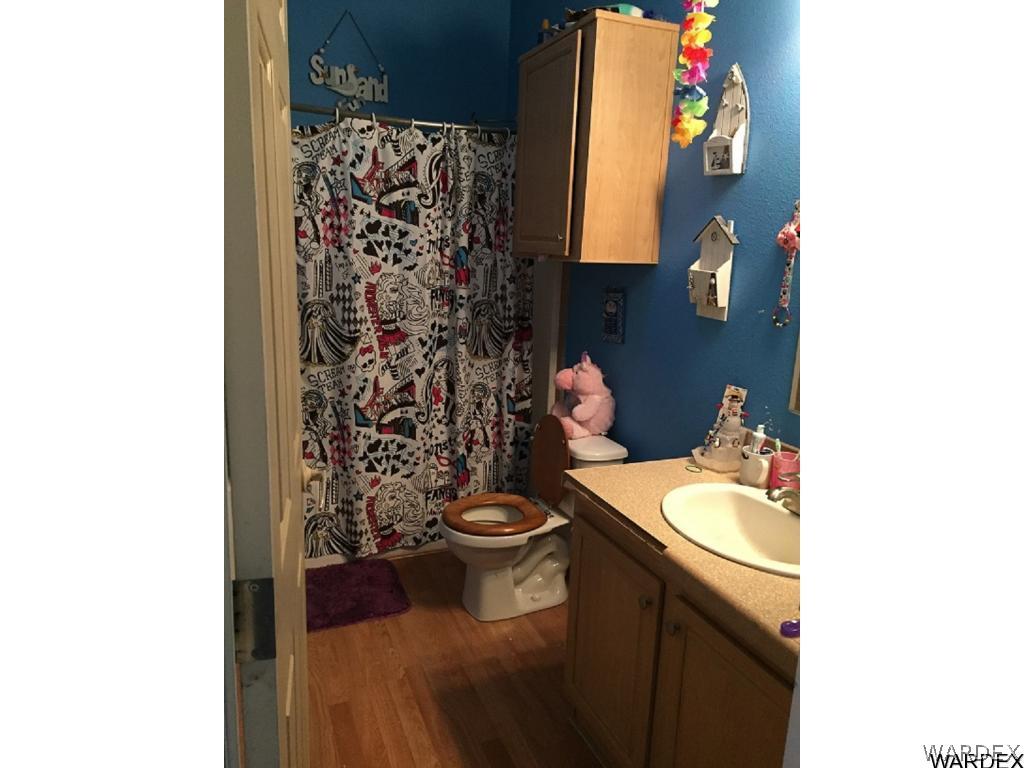 3995 Eloy Road, Unit 66 Golden Valley, AZ 86413 - Photo 21 of 27 a bathroom with a sink and a toilet
