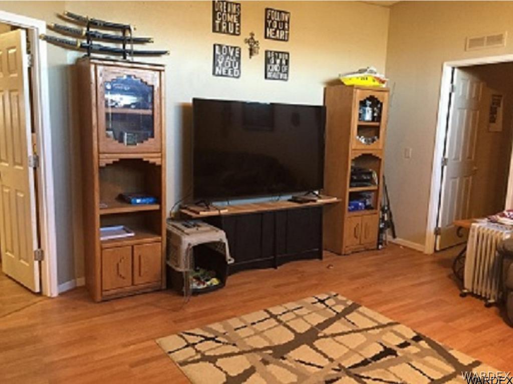 3995 Eloy Road, Unit 66 Golden Valley, AZ 86413 - Photo 6 of 27 a room with furniture and a flat screen tv