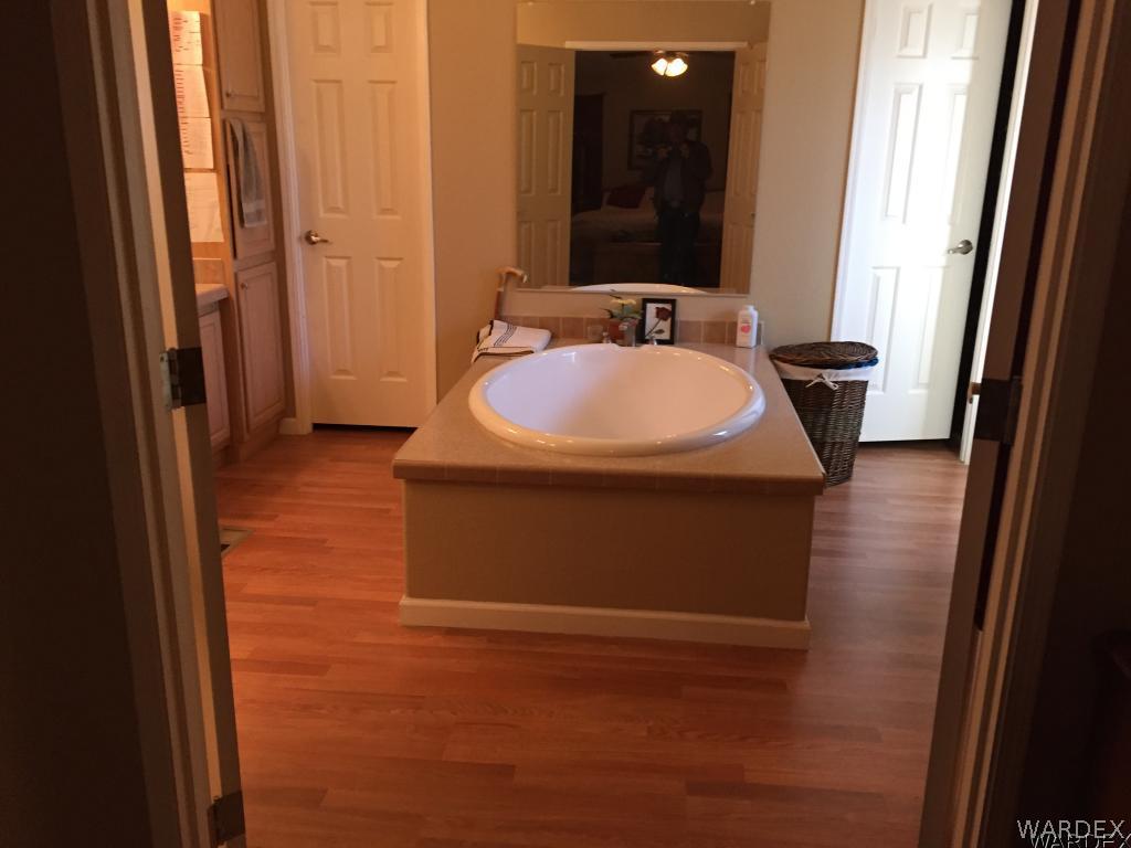 3995 Eloy Road, Unit 66 Golden Valley, AZ 86413 - Photo 8 of 27 a bathroom with a sink and a mirror