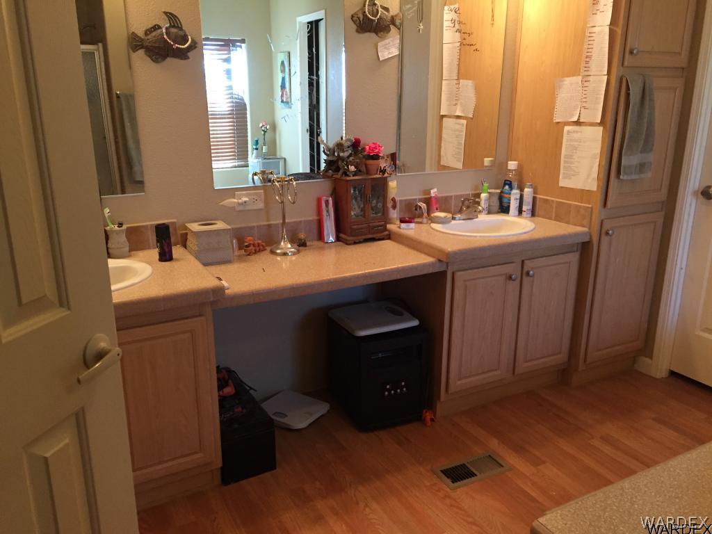 3995 Eloy Road, Unit 66 Golden Valley, AZ 86413 - Photo 9 of 27 a bathroom with a double vanity sink and a mirror