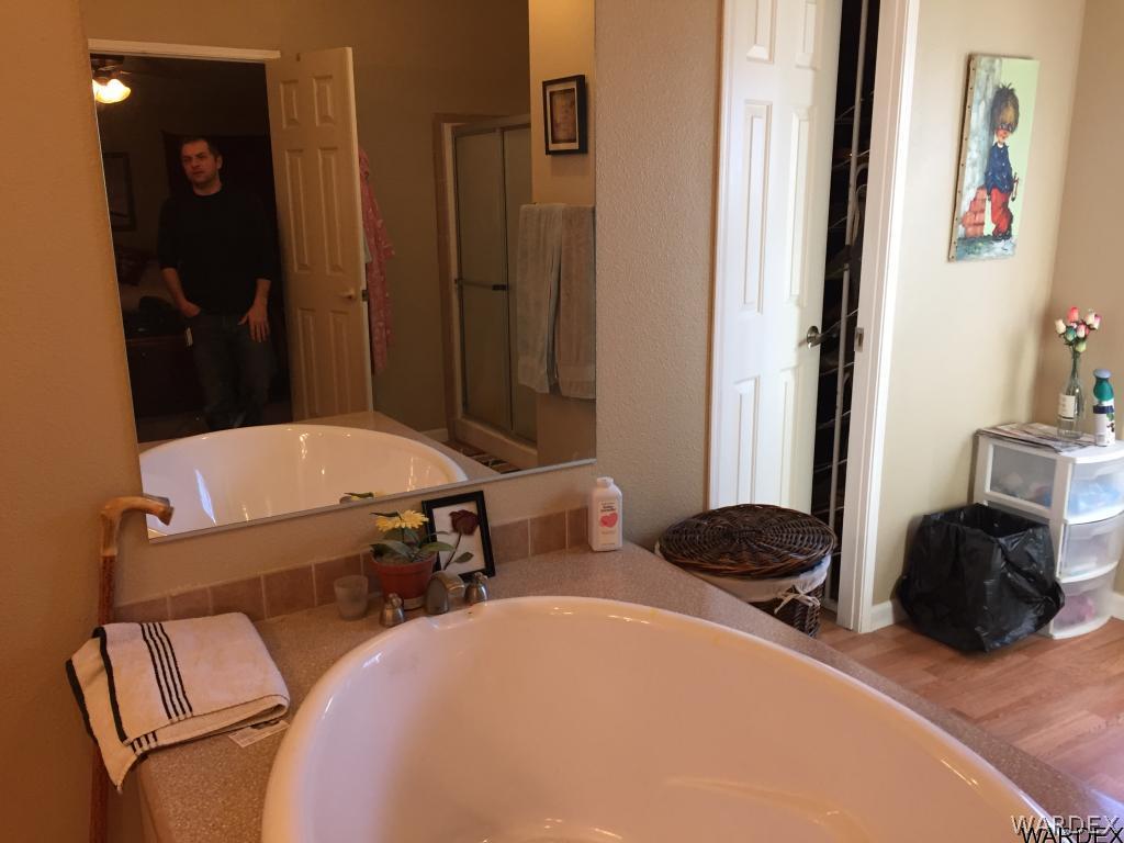 3995 Eloy Road, Unit 66 Golden Valley, AZ 86413 - Photo 10 of 27 a bedroom with a bed and a mirror