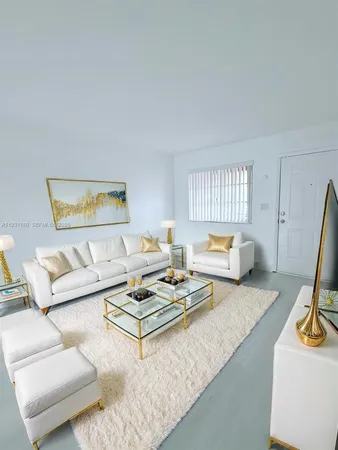 a living room with furniture a rug and a large window