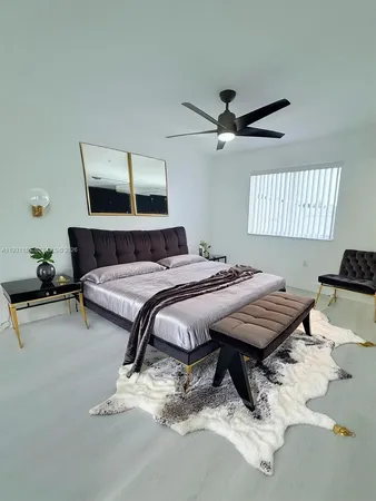 a bedroom with a bed and ceiling fan