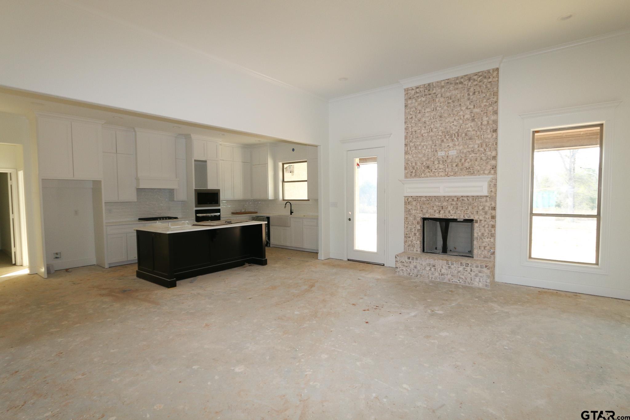 16503 Cooper Way Flint, TX 75762 - Photo 13 of 33 a view of a livingroom with kitchen and a fireplace