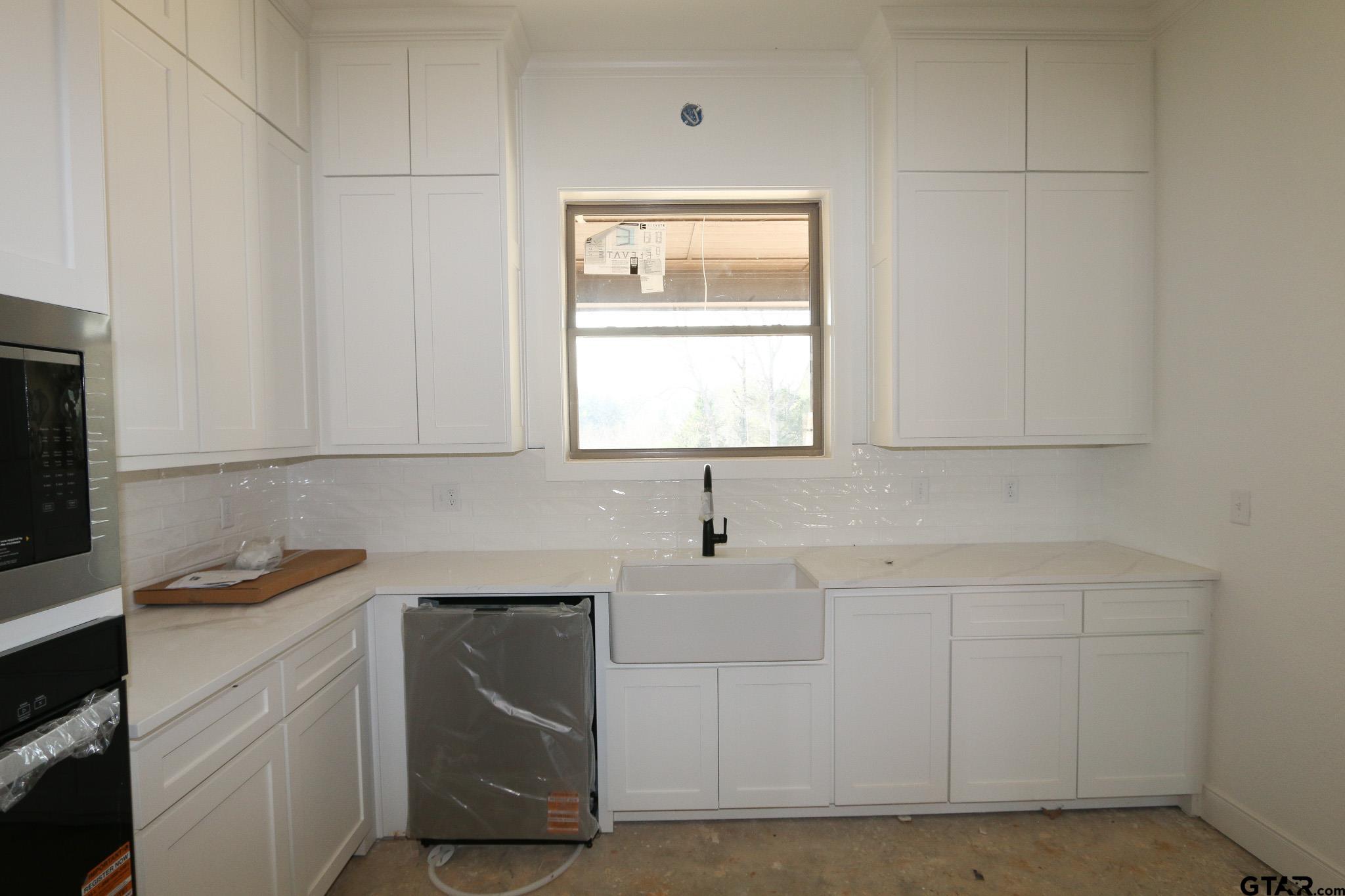 16503 Cooper Way Flint, TX 75762 - Photo 16 of 33 a kitchen with white cabinets and white appliances