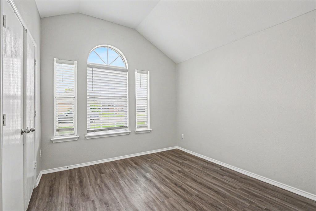 138 Kings Way Drive Rhome, TX 76078 - Photo 14 of 16 an empty room with wooden floor and windows