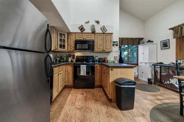 a kitchen with stainless steel appliances granite countertop a stove a sink dishwasher and a refrigerator