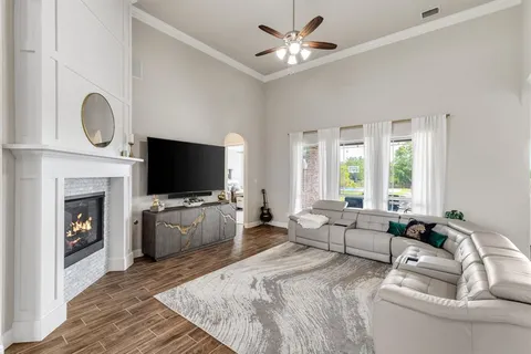 a living room with furniture fireplace and flat screen tv
