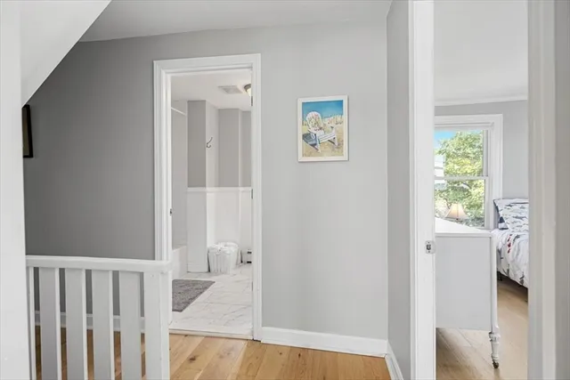 a view of a hallway with wooden floor and entryway