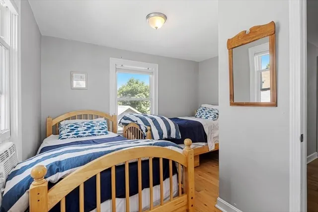 a bedroom with two beds and a window