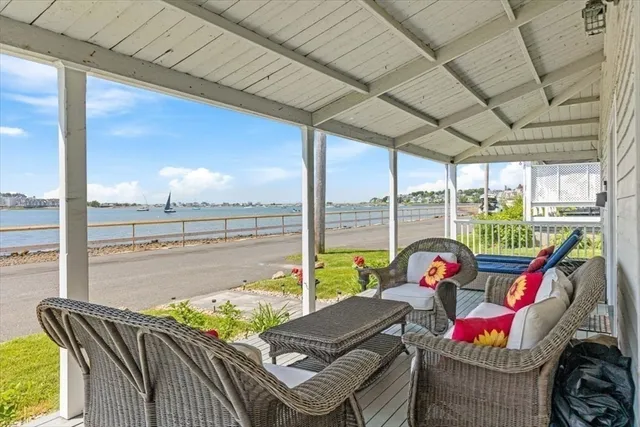 a living room with furniture floor to ceiling window and a table