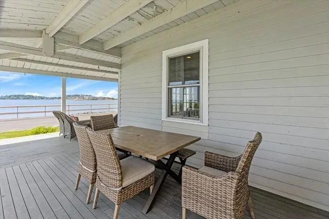 a view of a patio with table and chairs and wooden floor