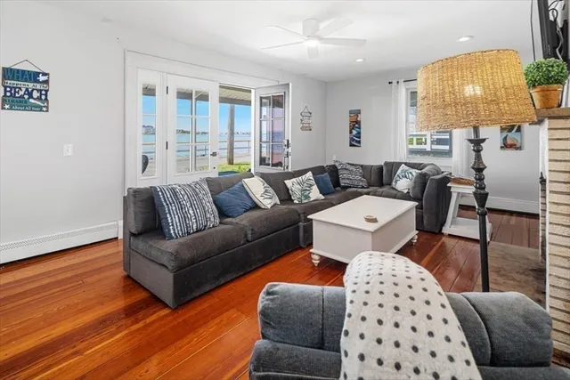a living room with furniture a lamp and a window