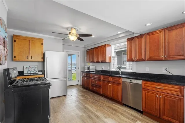 a kitchen with granite countertop appliances cabinets and a sink