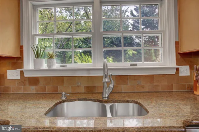 a dining area with furniture a chandelier and wooden floor