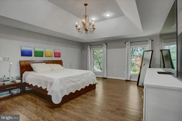 a bathroom with a granite countertop tub sink and mirror