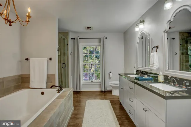 a kitchen with granite countertop a sink cabinets stainless steel appliances and a window