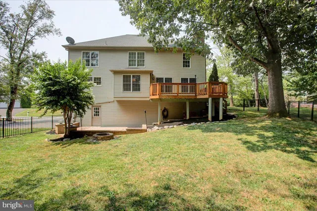 a backyard of a house with trees and outdoor seating
