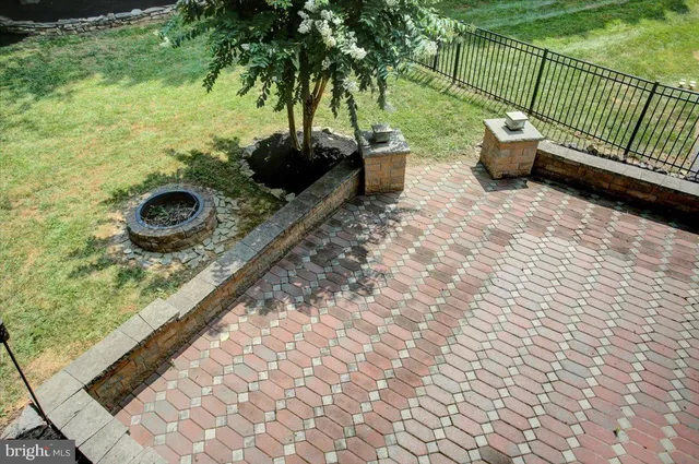 a view of a house with a yard and tree