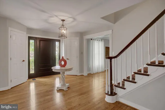 a view of entryway and hall with wooden floor