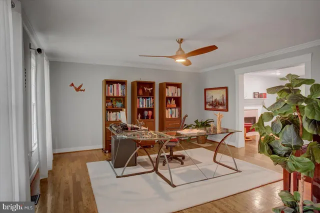 a view of a workspace with furniture and wooden floor