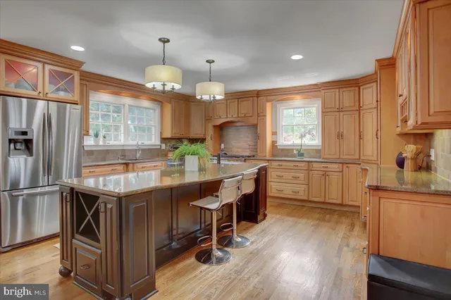 a kitchen with granite countertop center island and stainless steel appliances