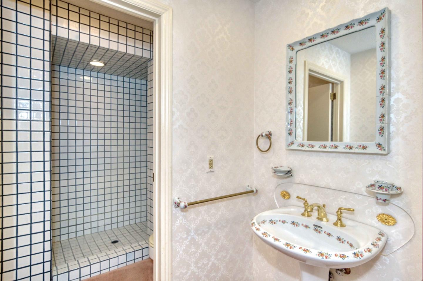 800 El Granada Boulevard El Granada, CA 94019 - Photo 49 of 57 a bathroom with a sink and a mirror