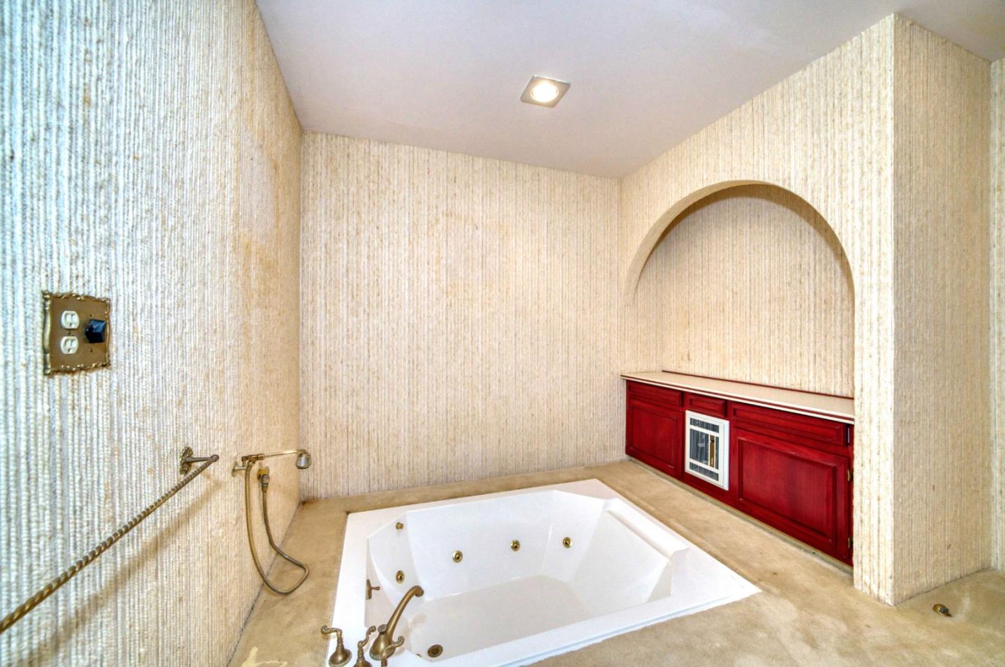 800 El Granada Boulevard El Granada, CA 94019 - Photo 50 of 57 a bathroom with a tub sink and mirror