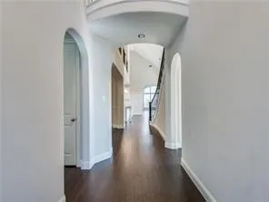 a view of a hallway with wooden floor