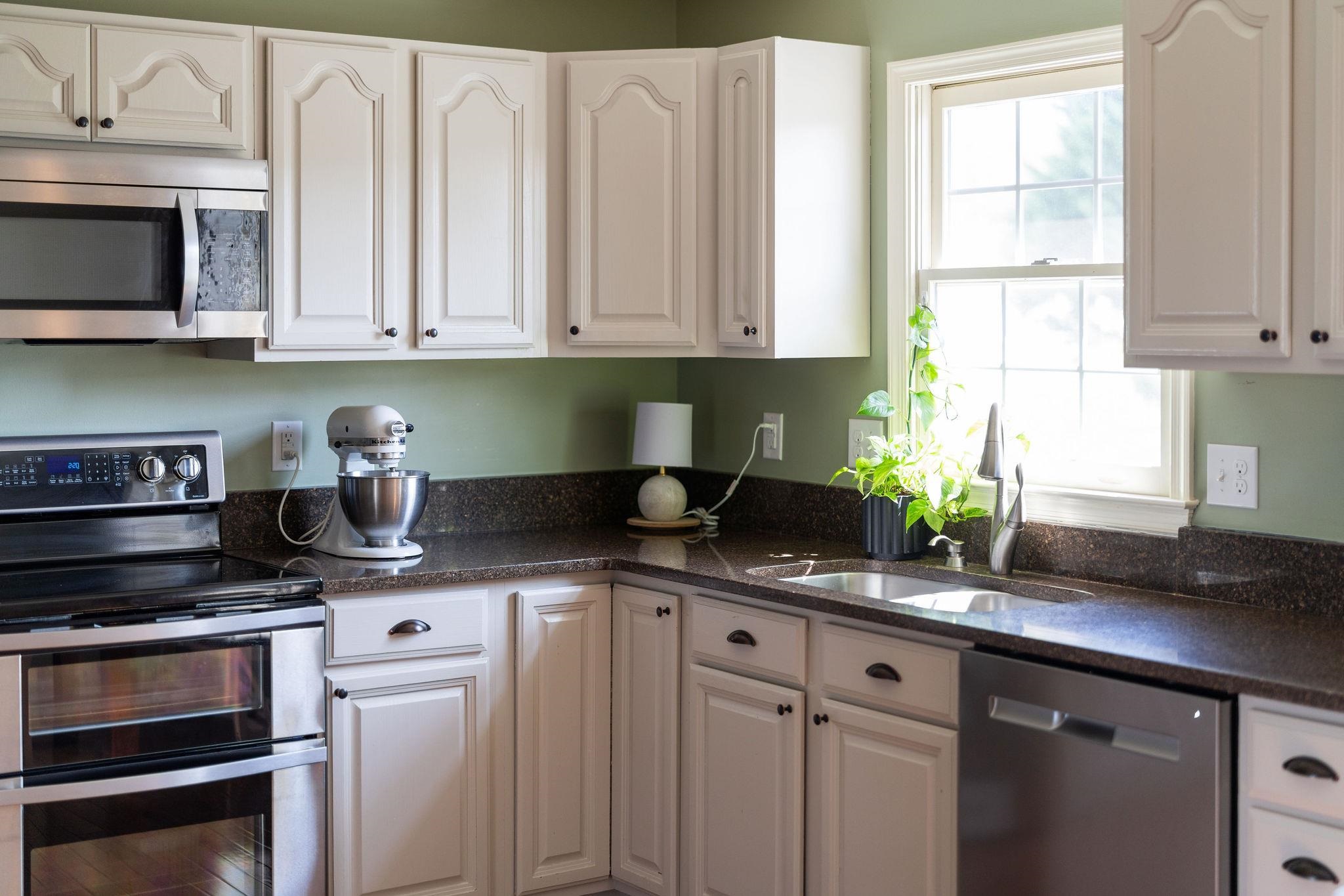 162 Cold Springs Road Stuarts Draft, VA 24477 - Photo 11 of 33 a kitchen with stainless steel appliances granite countertop a sink a stove and a microwave