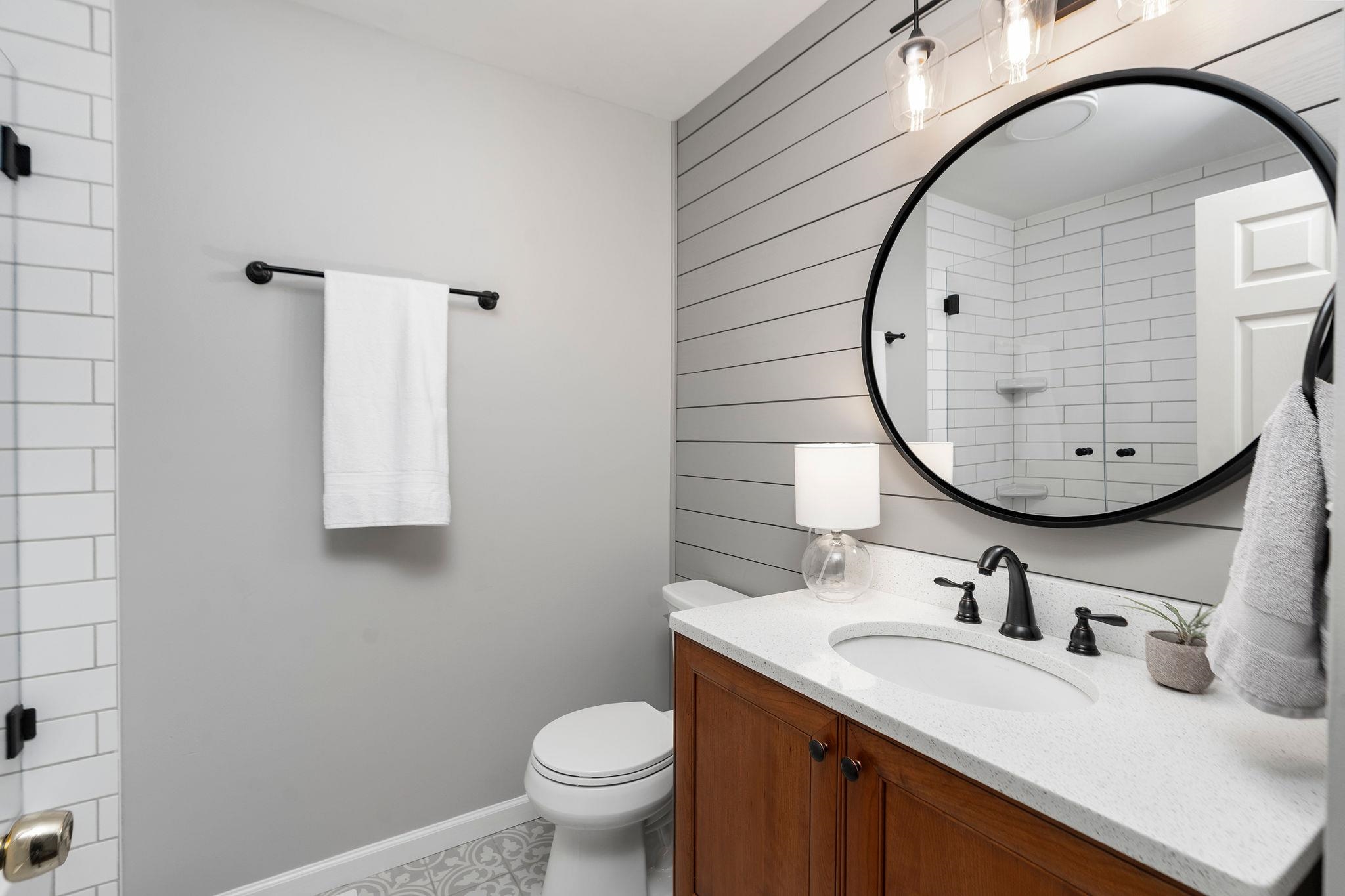 162 Cold Springs Road Stuarts Draft, VA 24477 - Photo 13 of 33 a bathroom with a granite countertop toilet a sink and mirror