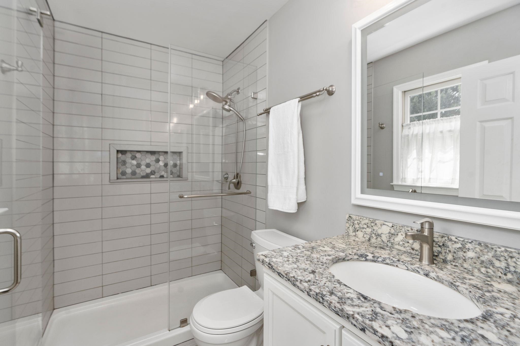 162 Cold Springs Road Stuarts Draft, VA 24477 - Photo 16 of 33 a bathroom with a granite countertop sink toilet a mirror and shower