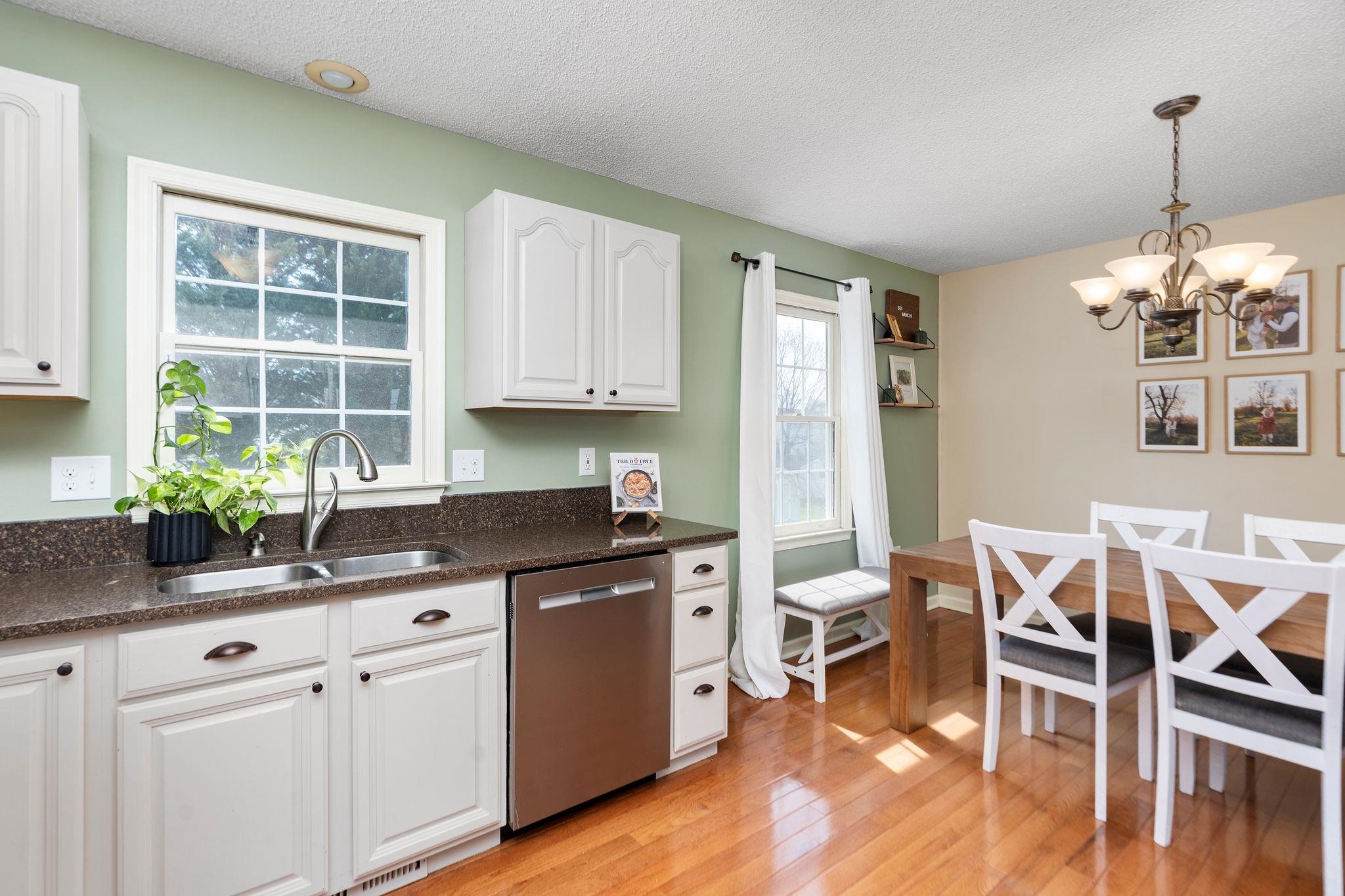162 Cold Springs Road Stuarts Draft, VA 24477 - Photo 10 of 33 a kitchen with granite countertop a table chairs stove and cabinets