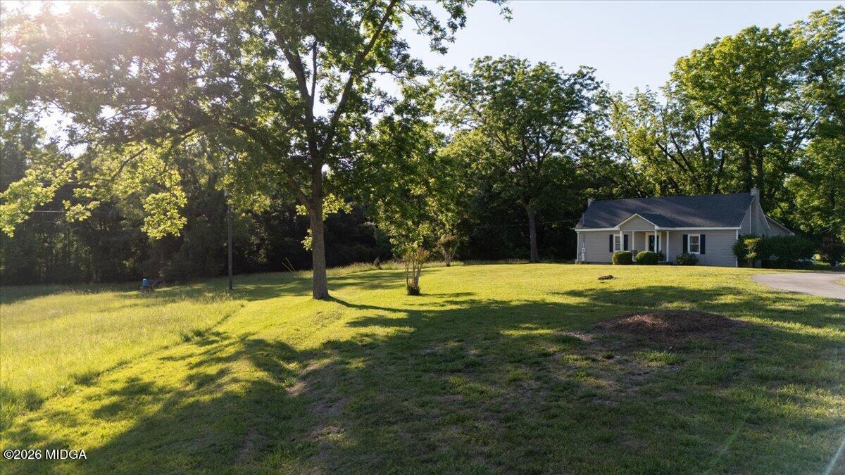 214 Howard Roberts Road Gray, GA 31032 - Photo 34 of 36 a swimming pool with outdoor seating and yard