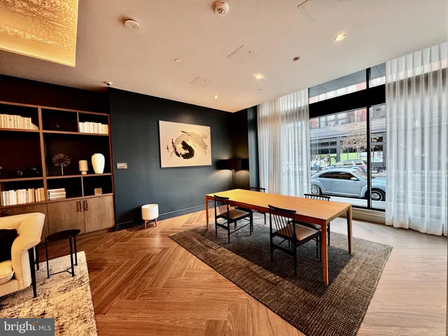 a living room with furniture a rug and a large window