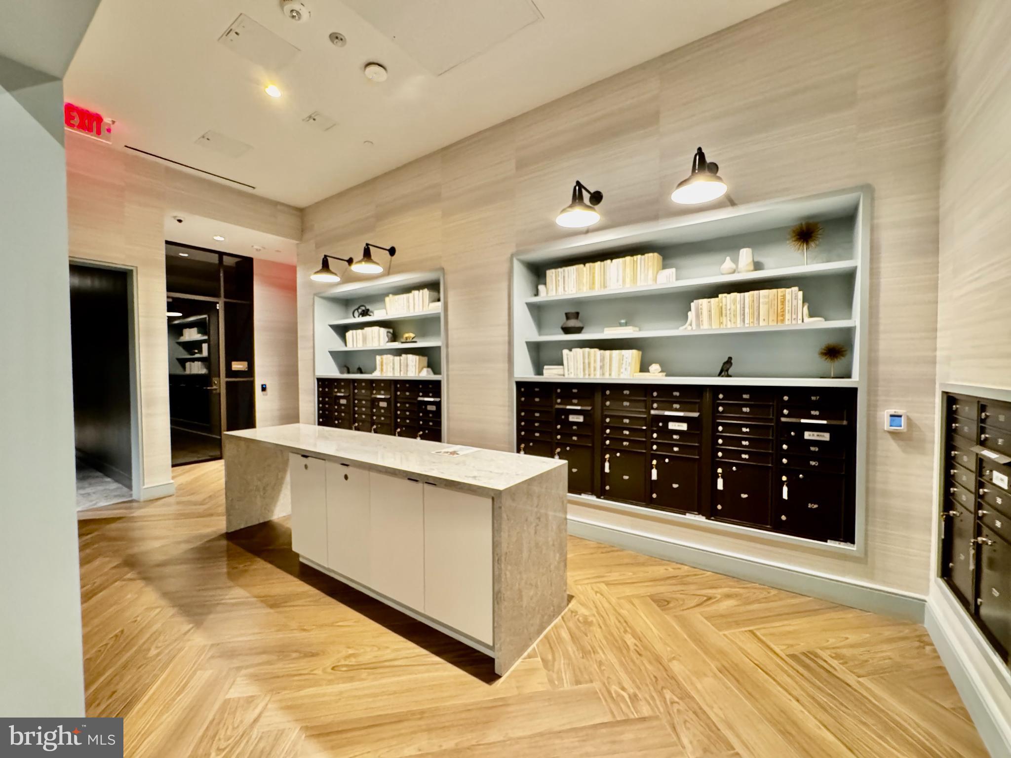 7175 12th Street Northwest, Unit 608 Washington, DC 20012 - Photo 14 of 24 a large white kitchen with stainless steel appliances a large counter top a stove and a refrigerator