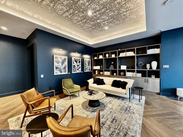 a living room with furniture lamp and rug