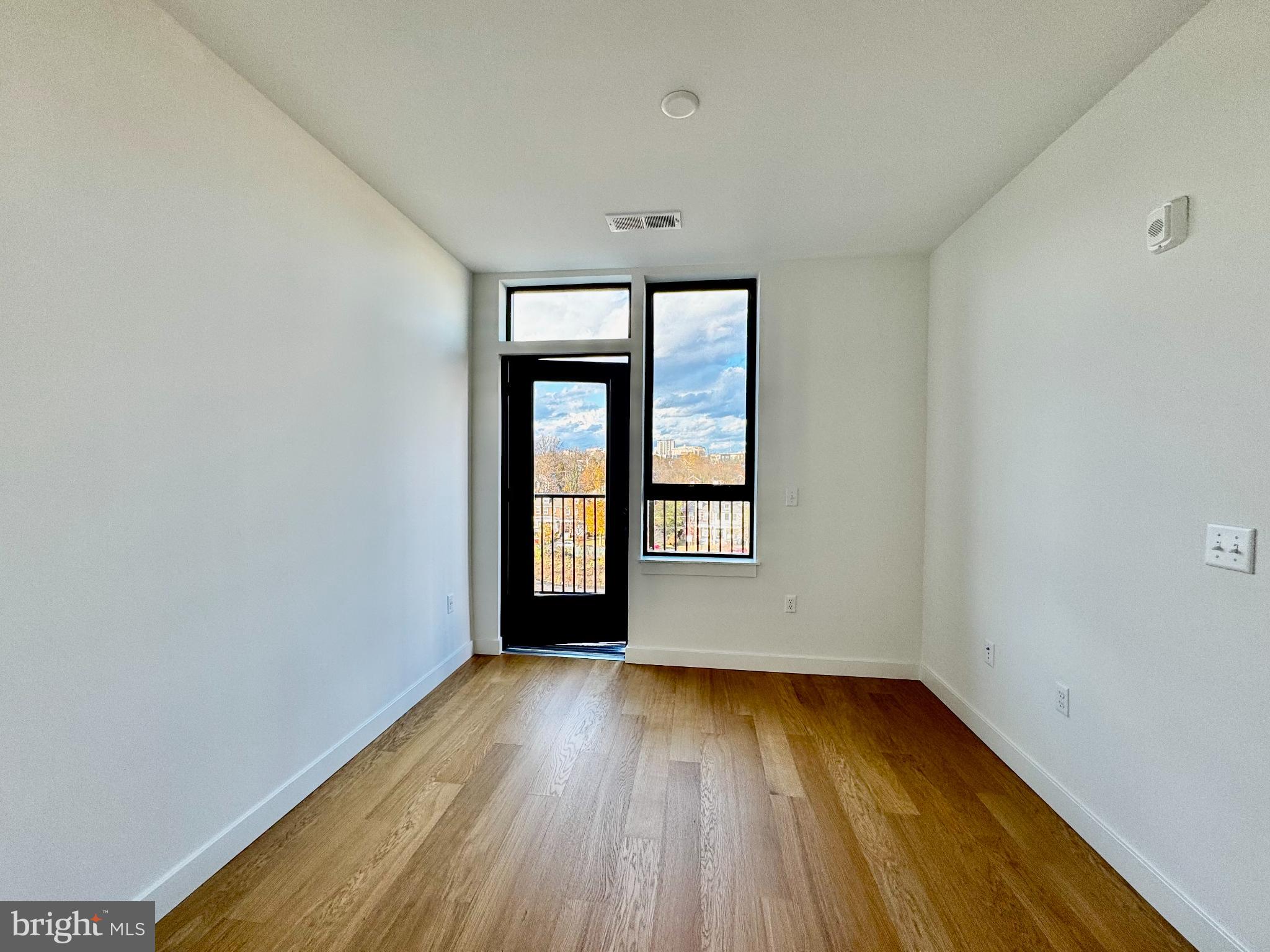 7175 12th Street Northwest, Unit 608 Washington, DC 20012 - Photo 20 of 24 wooden floor in an empty room with a window