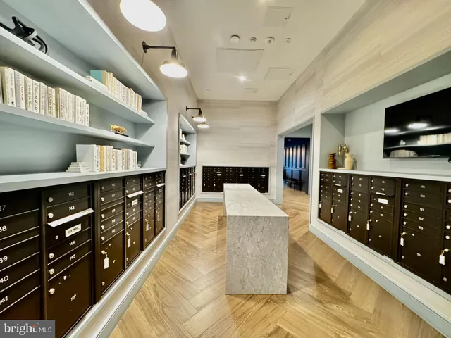 a large living room with stainless steel appliances kitchen island granite countertop a large kitchen island a stove a sink a dining table and chairs with wooden floor