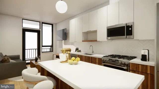 a kitchen with a stove a sink and a microwave