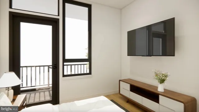 a view of a hallway with wooden floor and a bathroom